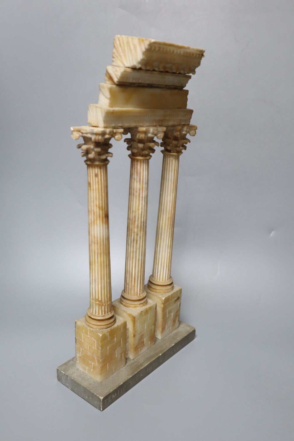 After the Antique. A Grand Tour carved and stained alabaster model of Ruins, height 34cm